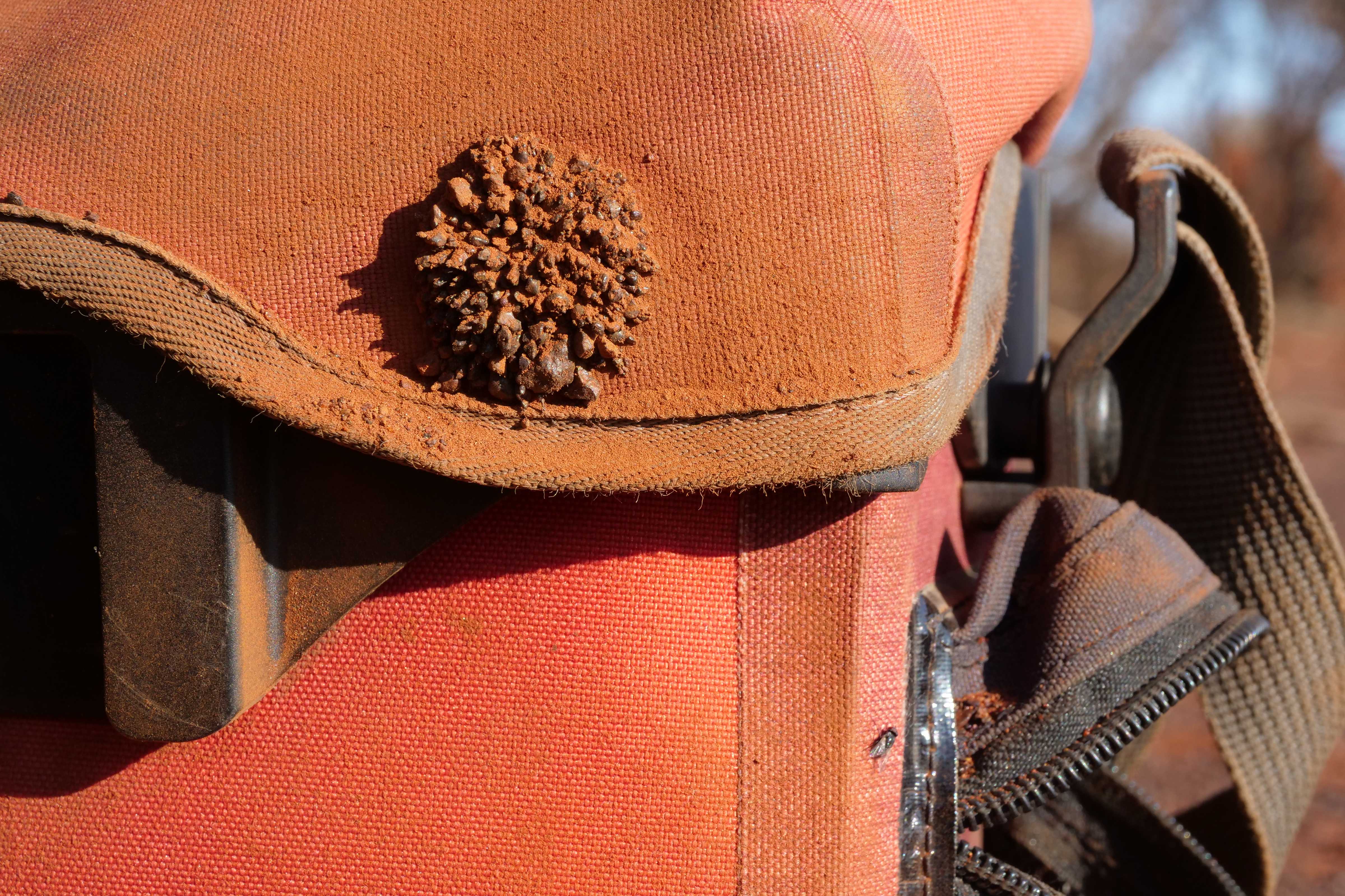 Magnetite grains sticking to magnetic latch on bicycle handlebar bag.